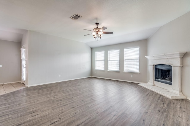 unfurnished living room featuring ceiling fan, light wood-type flooring, and vaulted ceiling