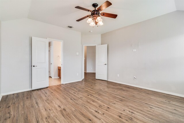 unfurnished bedroom with light hardwood / wood-style floors, vaulted ceiling, ceiling fan, and ensuite bathroom