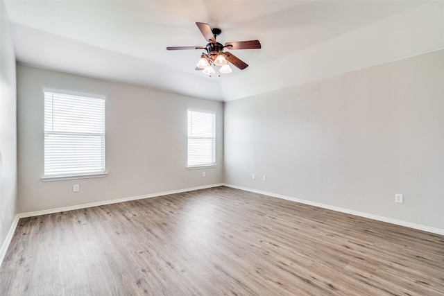 empty room featuring hardwood / wood-style floors, ceiling fan, and lofted ceiling