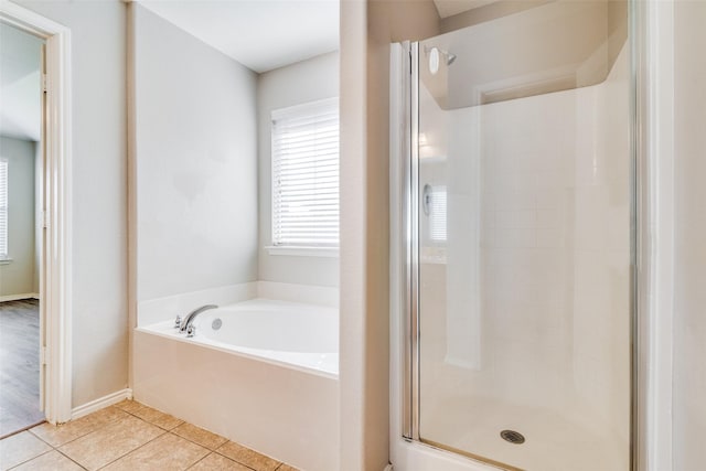 bathroom featuring tile patterned flooring and separate shower and tub