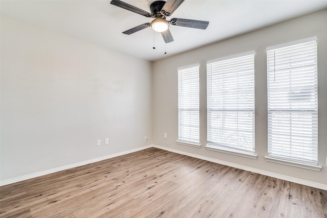 spare room featuring light hardwood / wood-style flooring and ceiling fan