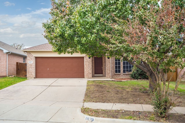 obstructed view of property with a garage