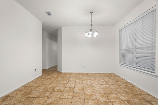 spare room with light tile patterned floors and a notable chandelier