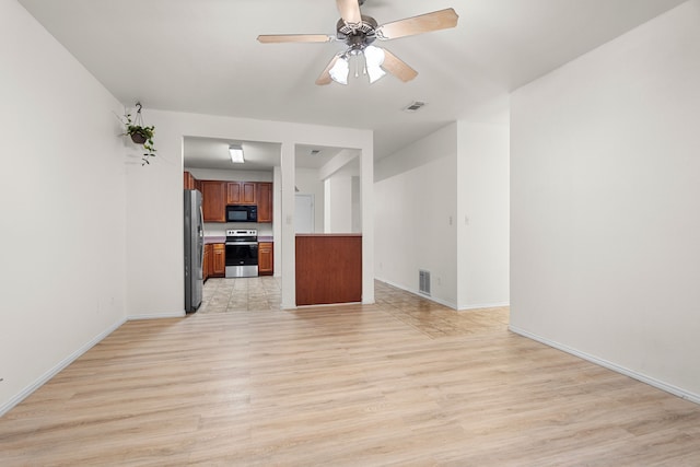 unfurnished living room featuring ceiling fan and light wood-type flooring