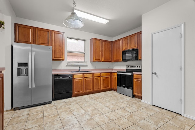 kitchen with sink, light tile patterned floors, and black appliances