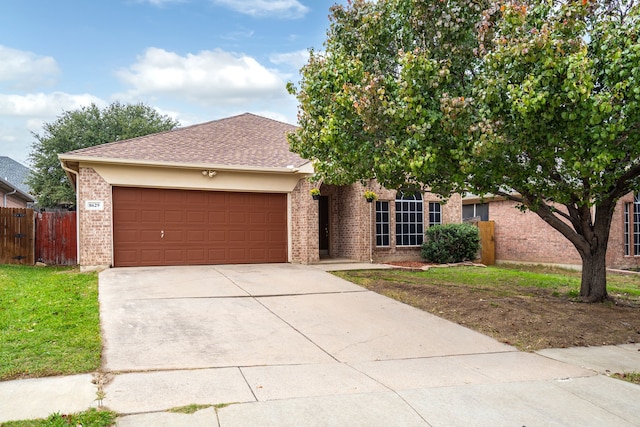 view of front of property with a garage and a front lawn