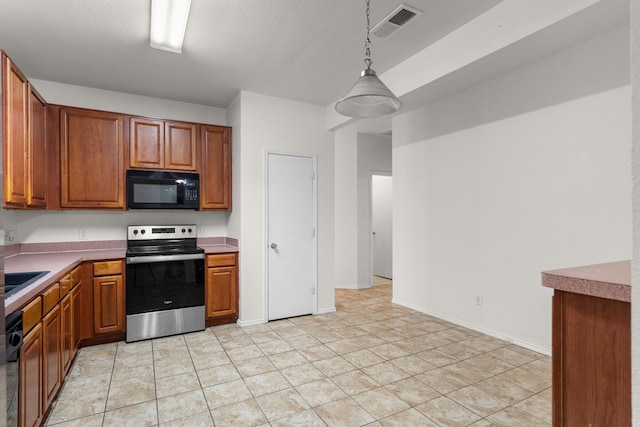 kitchen featuring decorative light fixtures, light tile patterned floors, a textured ceiling, and black appliances