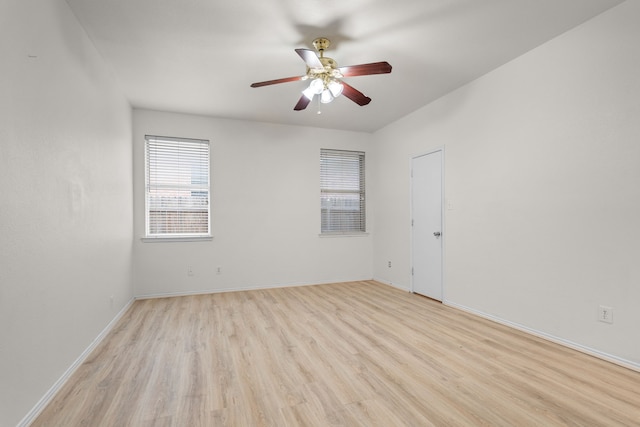 empty room with light hardwood / wood-style flooring and ceiling fan