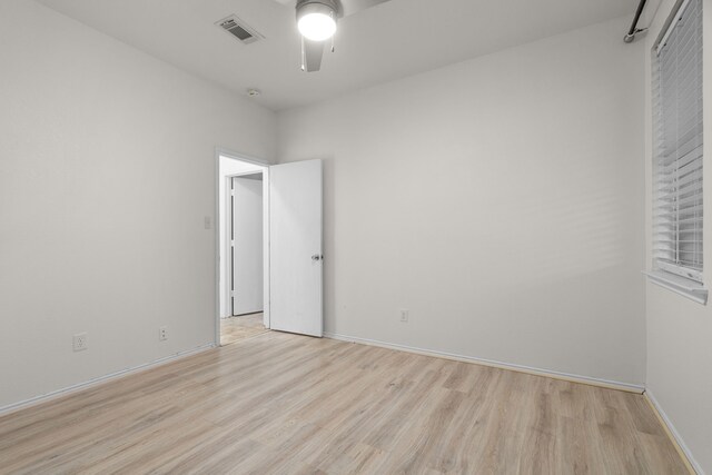 unfurnished room with ceiling fan and light wood-type flooring