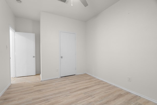 unfurnished bedroom featuring ceiling fan and light wood-type flooring