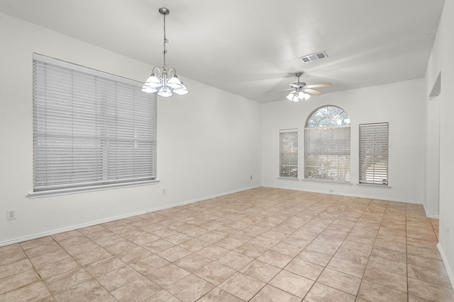 unfurnished room with ceiling fan with notable chandelier