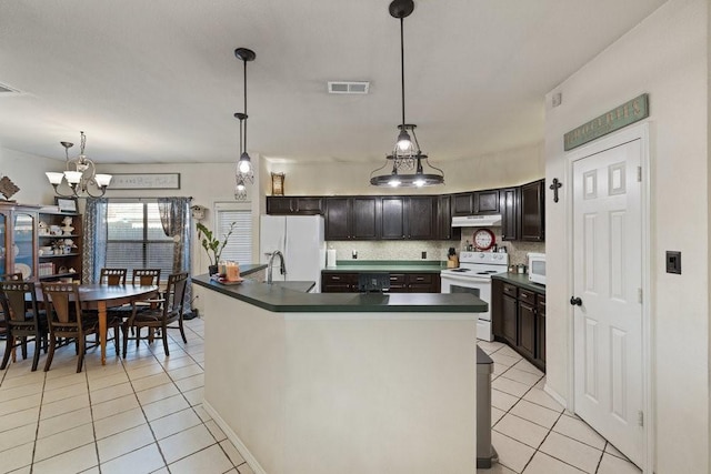 kitchen featuring dark brown cabinets, decorative light fixtures, white appliances, and light tile patterned floors