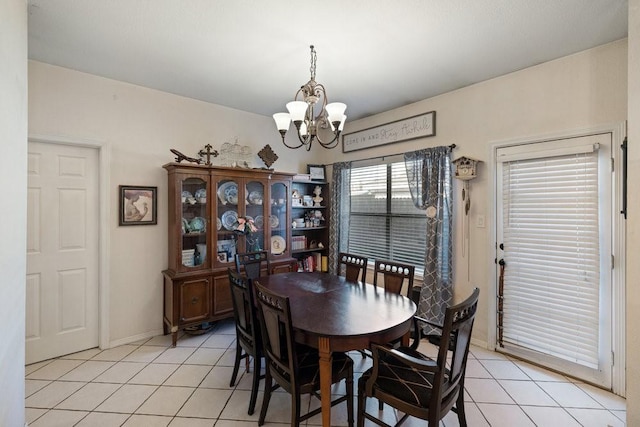 tiled dining area featuring an inviting chandelier