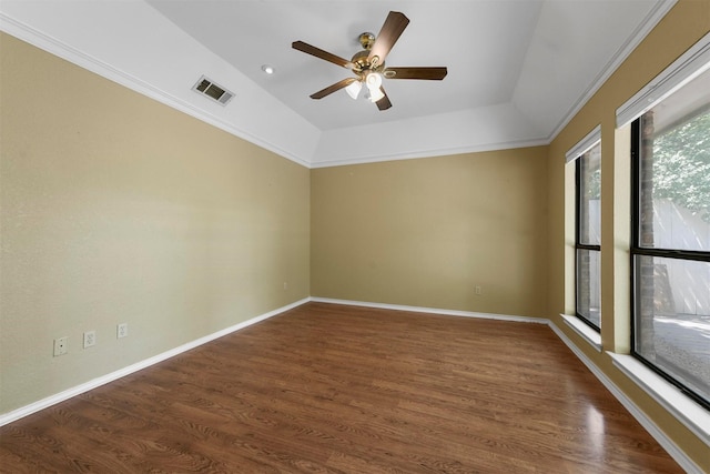 spare room with dark hardwood / wood-style floors, vaulted ceiling, and ceiling fan