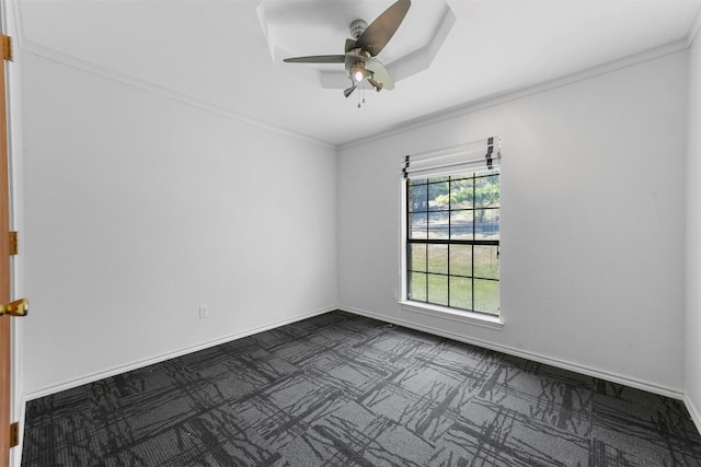 carpeted empty room with ceiling fan and ornamental molding