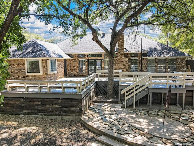 back of house featuring a wooden deck