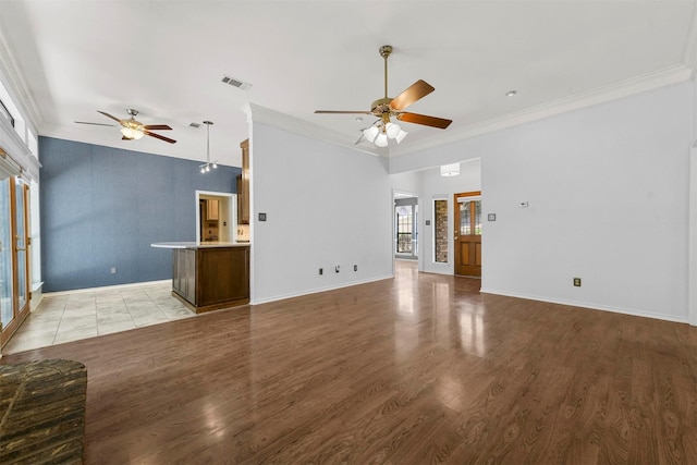 unfurnished living room featuring ceiling fan, crown molding, and light hardwood / wood-style flooring