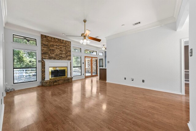 unfurnished living room featuring crown molding, a fireplace, and hardwood / wood-style flooring