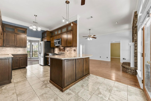 kitchen with pendant lighting, ceiling fan with notable chandelier, light tile patterned flooring, kitchen peninsula, and stainless steel appliances