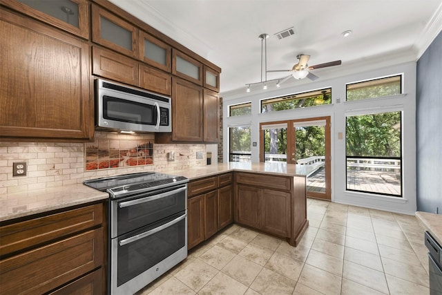 kitchen with ceiling fan, stainless steel appliances, tasteful backsplash, kitchen peninsula, and light tile patterned floors