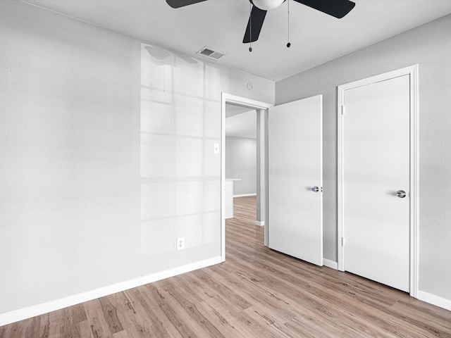 unfurnished bedroom featuring ceiling fan and light hardwood / wood-style flooring