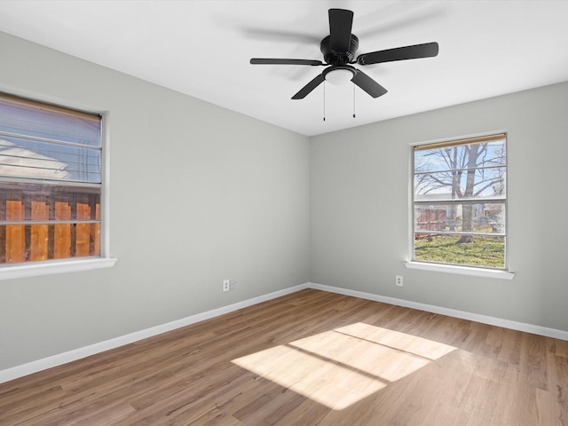 empty room featuring hardwood / wood-style floors and ceiling fan