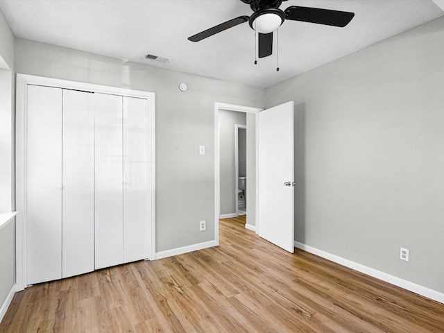 unfurnished bedroom featuring ceiling fan, light hardwood / wood-style floors, and a closet