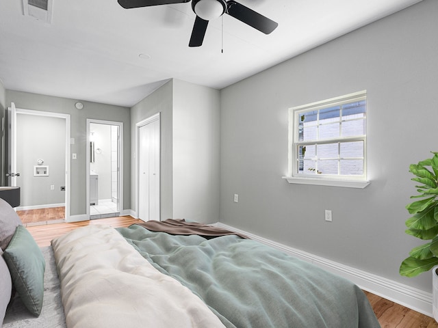 bedroom with hardwood / wood-style flooring, ceiling fan, and ensuite bathroom