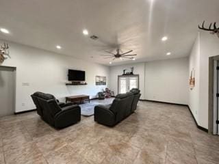 living room featuring ceiling fan and french doors