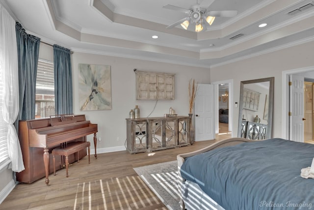 bedroom with crown molding, ceiling fan, and a raised ceiling