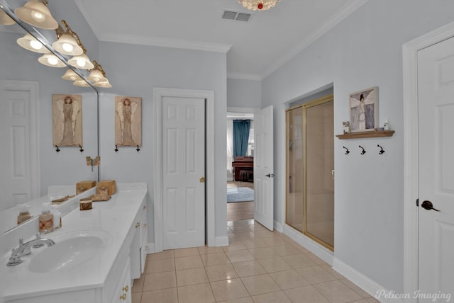 bathroom featuring tile patterned flooring, vanity, a shower with door, and crown molding