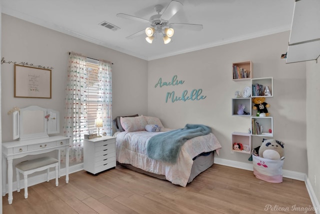 bedroom featuring crown molding, ceiling fan, and light wood-type flooring