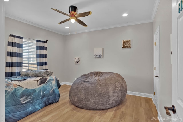 bedroom featuring wood-type flooring, crown molding, and ceiling fan