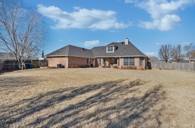 back of property featuring a lawn