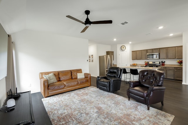 living room featuring lofted ceiling, ceiling fan, and dark hardwood / wood-style floors