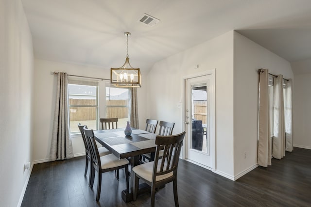 dining area with vaulted ceiling, a chandelier, and dark hardwood / wood-style floors