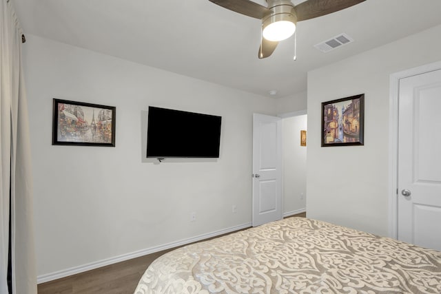 bedroom with ceiling fan and dark wood-type flooring