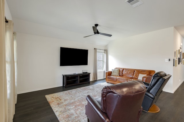 living room with dark hardwood / wood-style flooring, ceiling fan, and lofted ceiling