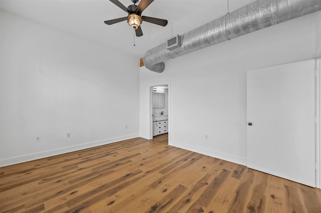 unfurnished bedroom with hardwood / wood-style flooring, ensuite bath, and ceiling fan