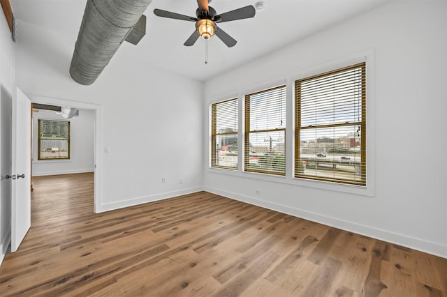 empty room with ceiling fan and wood-type flooring