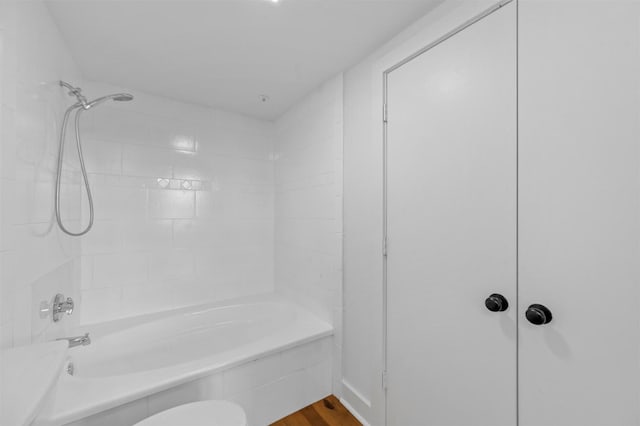 bathroom with wood-type flooring and tiled shower / bath combo