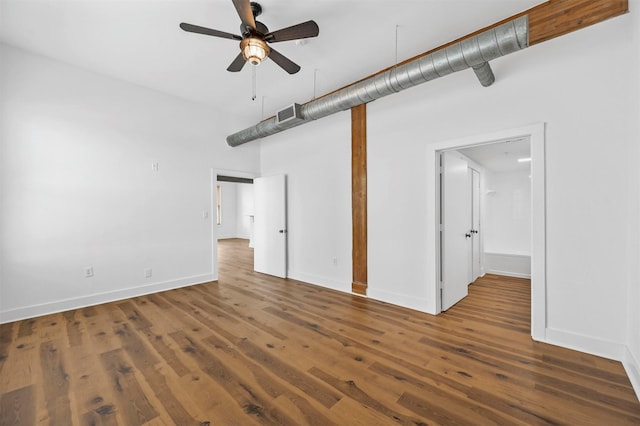 empty room featuring ceiling fan and dark hardwood / wood-style flooring