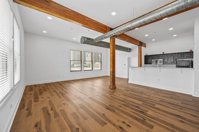 unfurnished living room with dark wood-type flooring