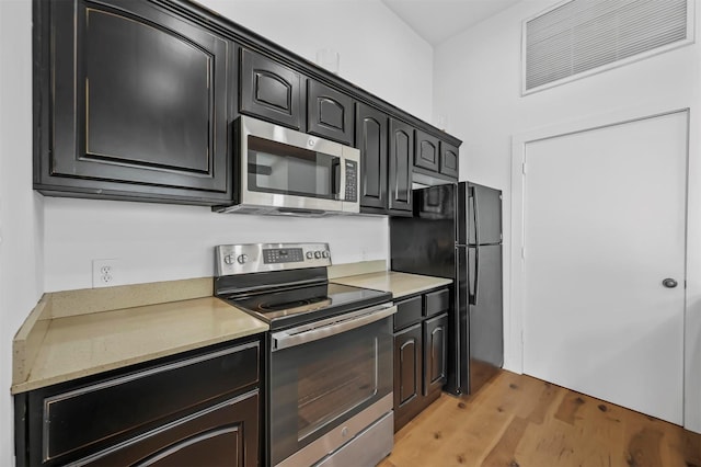 kitchen featuring light hardwood / wood-style flooring and appliances with stainless steel finishes