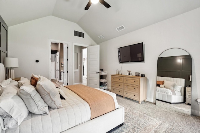 carpeted bedroom featuring ceiling fan, lofted ceiling, and ensuite bath