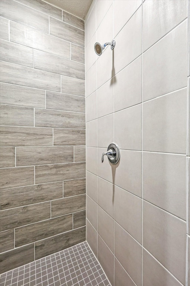 bathroom with a tile shower