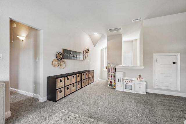 playroom featuring carpet flooring and vaulted ceiling