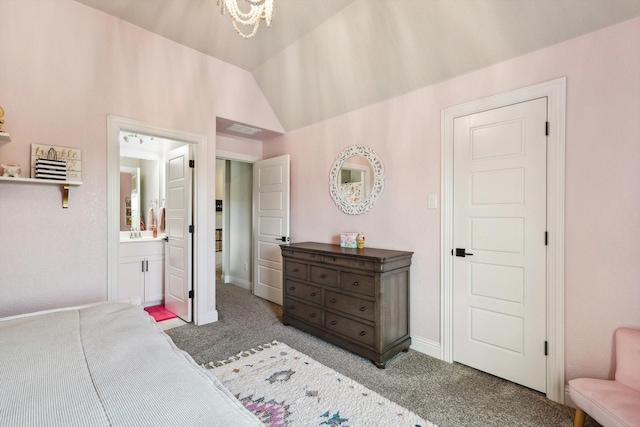 carpeted bedroom with sink, a chandelier, vaulted ceiling, and ensuite bathroom