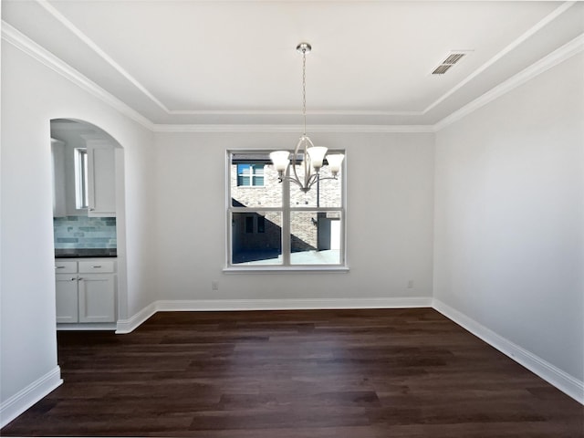 unfurnished dining area with ornamental molding, dark wood-type flooring, and a chandelier