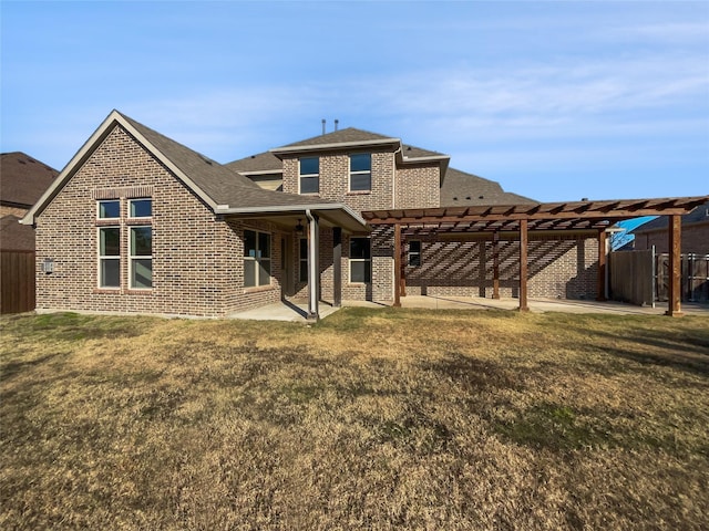 rear view of house featuring a yard, a pergola, and a patio area